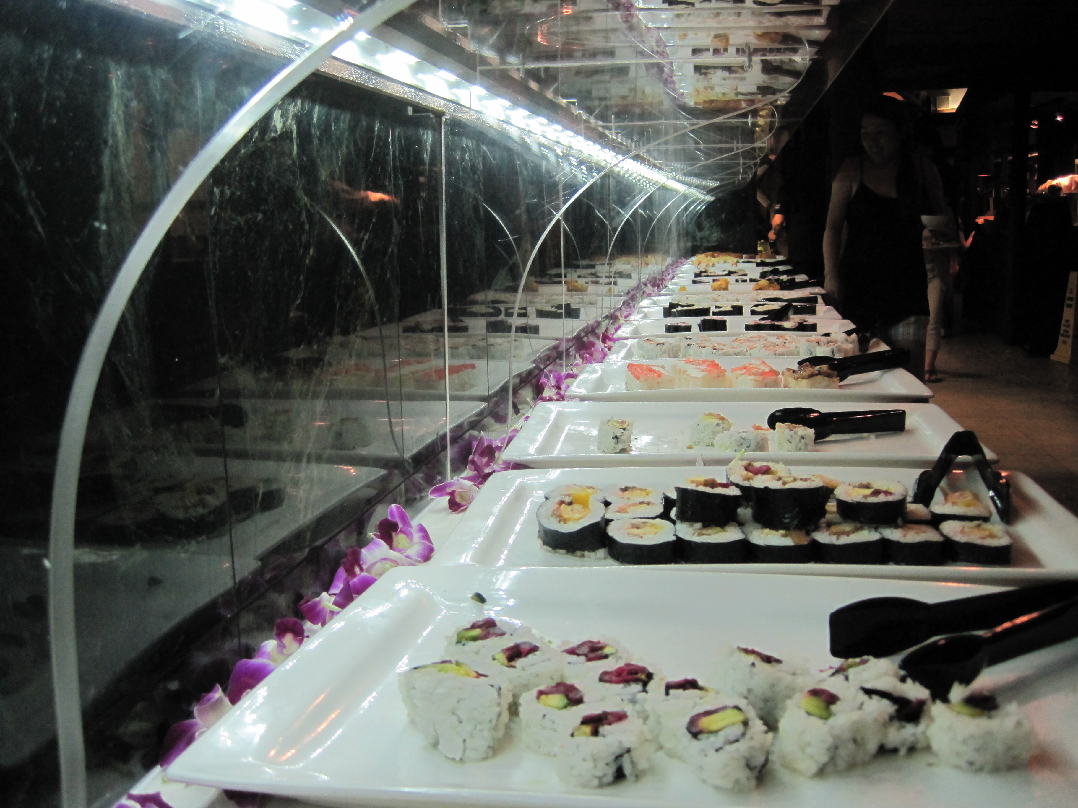 Sushi buffet display with orchid garnish