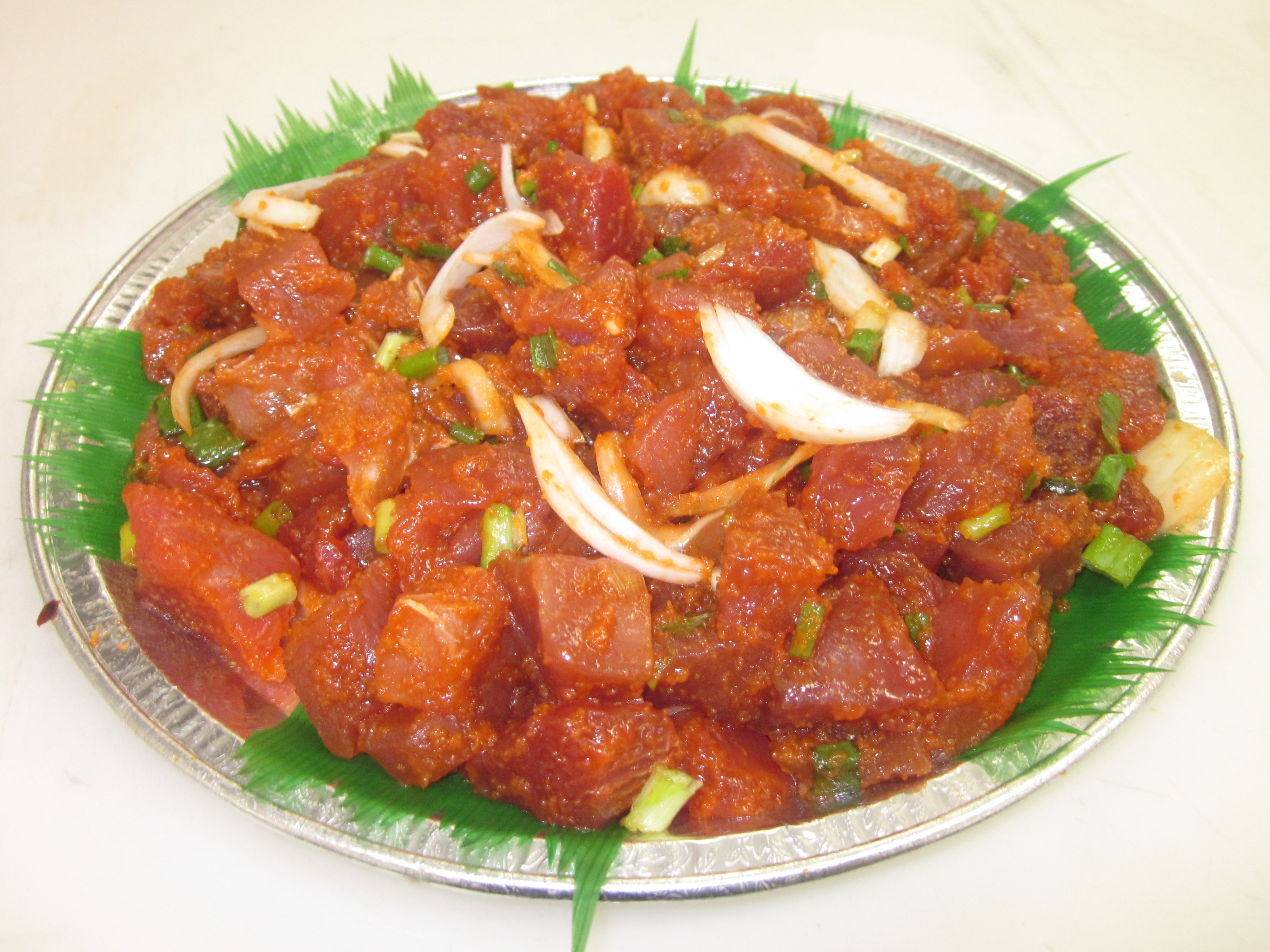 Spicy ahi poke platter with onions and seaweed