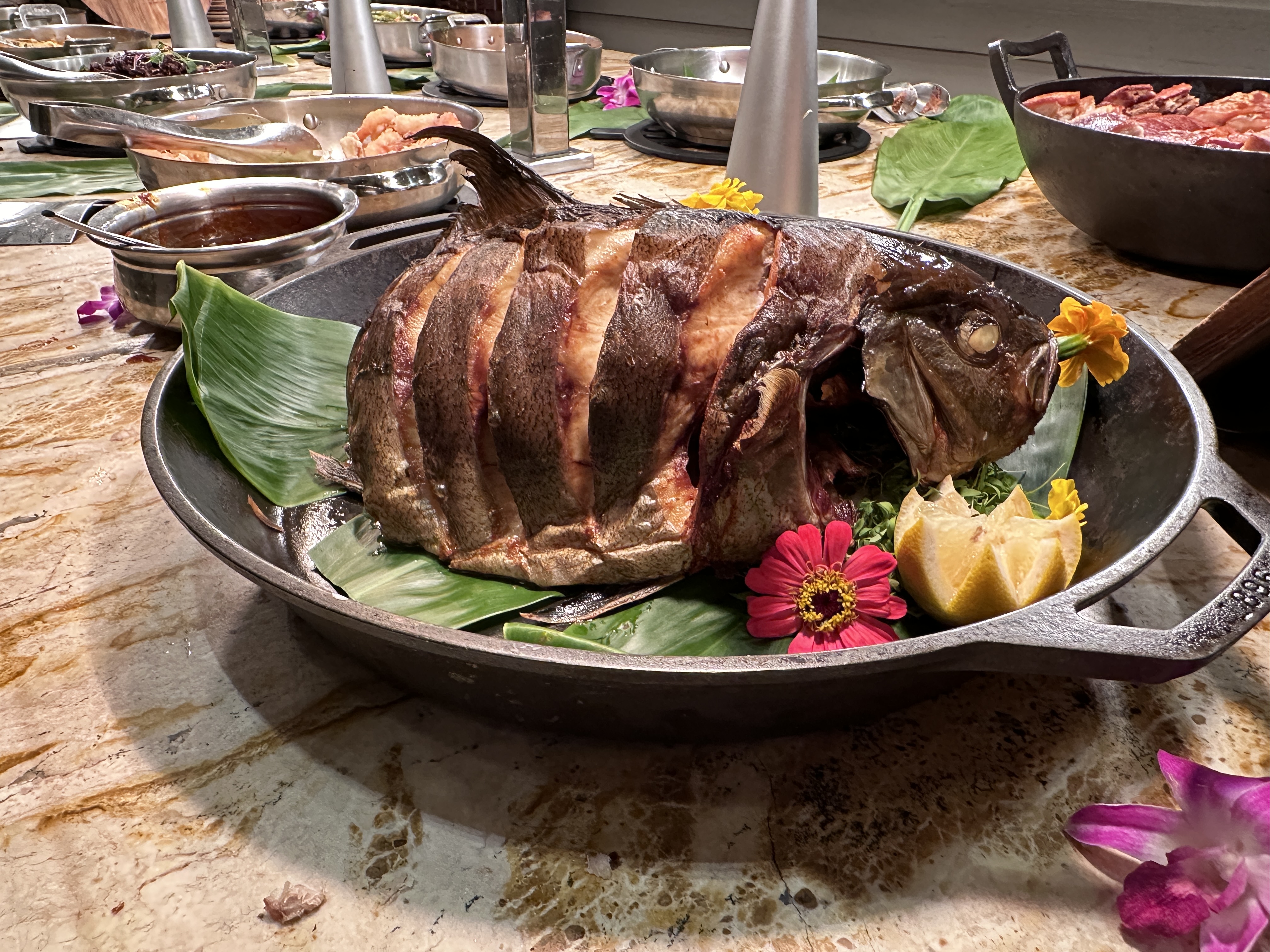 Whole roasted fish with orchid garnish at a local Oahu restaurant
